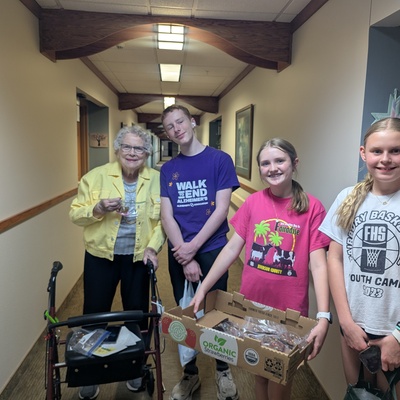 Handing out baked goods to residents at Cedarwood