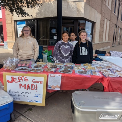 Having a bake sale to earn money to donate to two little boys to receive a service dog